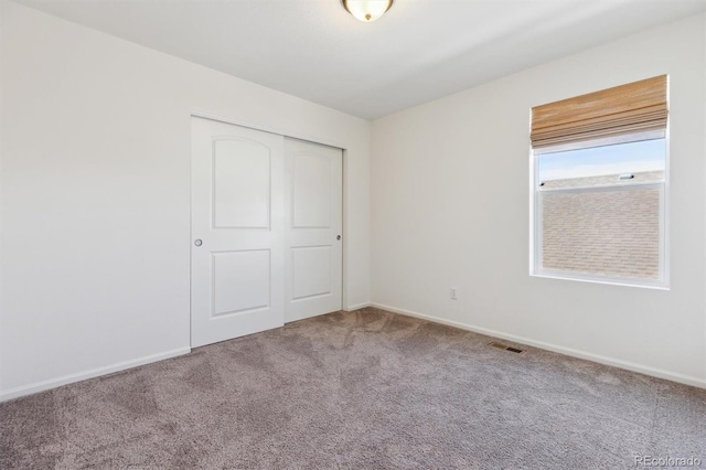 6214 Long Branch Dr, Parker, CO 80134 - unfurnished bedroom with baseboards, carpet flooring, a closet, and visible vents