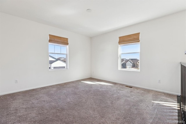 6214 Long Branch Dr, Parker, CO 80134 - empty room featuring carpet floors, baseboards, a healthy amount of sunlight, and visible vents