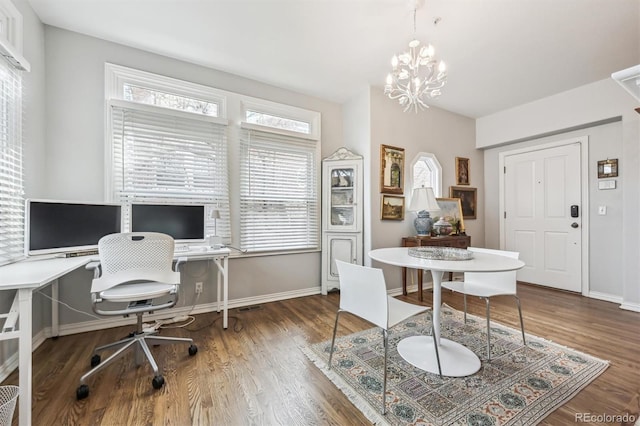 office area with dark wood-type flooring and a notable chandelier