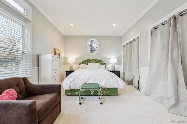 bedroom featuring ornamental molding and light colored carpet