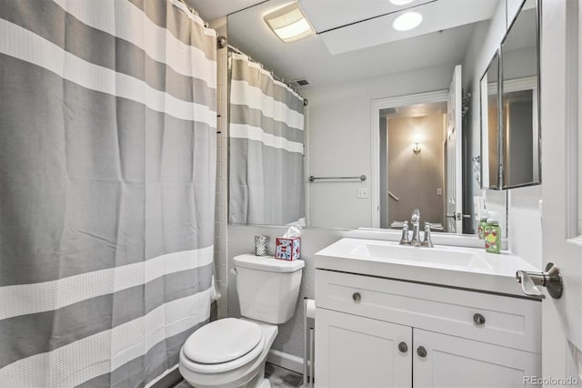 bathroom featuring vanity, toilet, and walk in shower