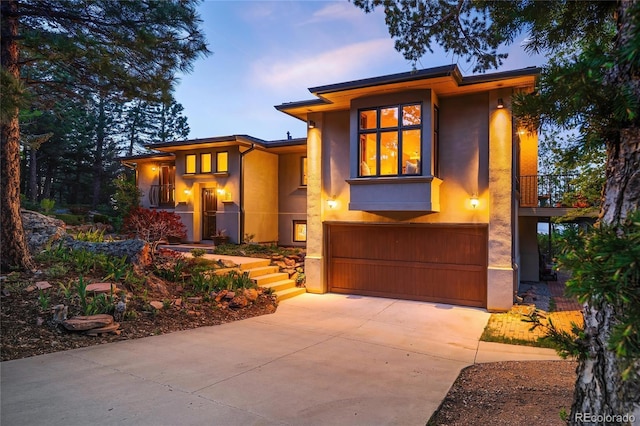 8932 Eastridge Rd, Golden, CO 80403 - prairie-style home with stucco siding, an attached garage, and concrete driveway