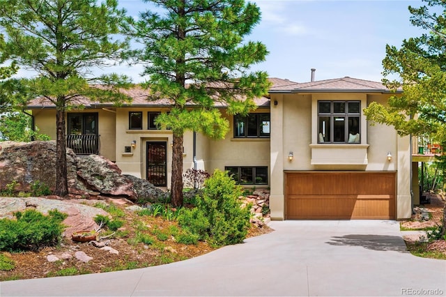 8932 Eastridge Rd, Golden, CO 80403 - view of front of property with stucco siding, driveway, and a garage