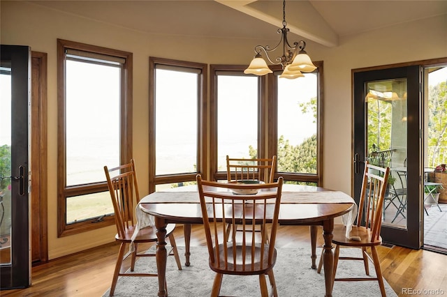 8932 Eastridge Rd, Golden, CO 80403 - dining space featuring light wood finished floors and a chandelier