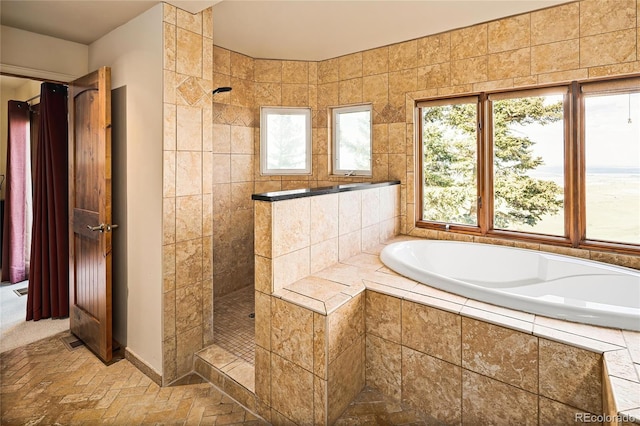 8932 Eastridge Rd, Golden, CO 80403 - bathroom featuring a garden tub, walk in shower, and baseboards