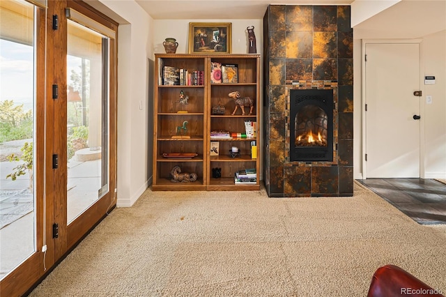 8932 Eastridge Rd, Golden, CO 80403 - living area with carpet flooring, a tiled fireplace, and baseboards