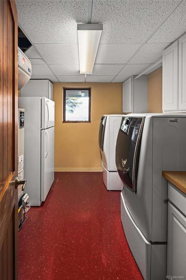 8932 Eastridge Rd, Golden, CO 80403 - laundry room with cabinet space, baseboards, and washing machine and dryer