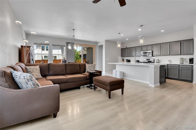 27853 E 8th Ave, Aurora, CO 80018 - living room with light wood finished floors, a ceiling fan, and recessed lighting