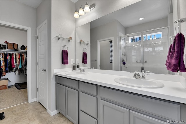 27853 E 8th Ave, Aurora, CO 80018 - bathroom with a stall shower, double vanity, and a spacious closet