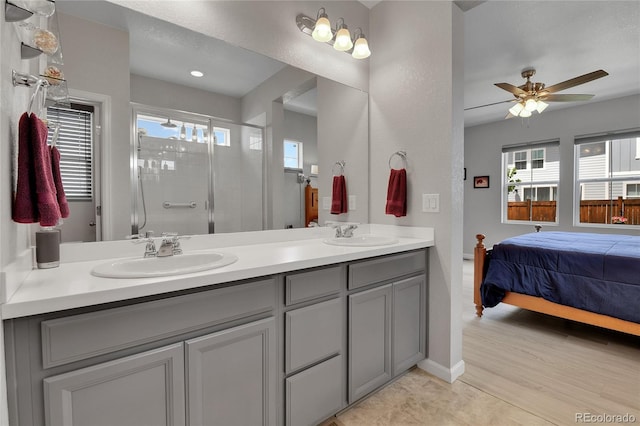 27853 E 8th Ave, Aurora, CO 80018 - ensuite bathroom with double vanity, a shower stall, and a ceiling fan