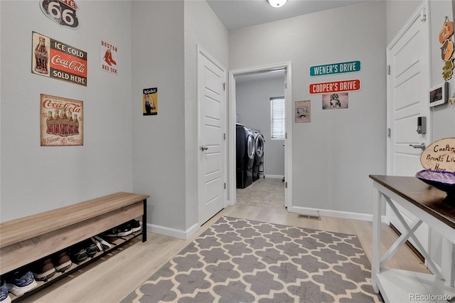 27853 E 8th Ave, Aurora, CO 80018 - mudroom with washer and clothes dryer and light wood finished floors