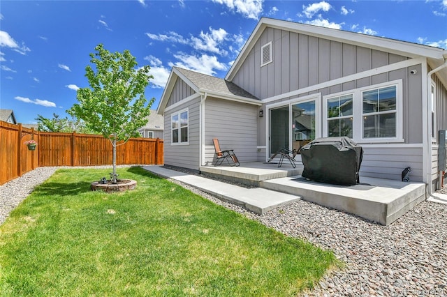 27853 E 8th Ave, Aurora, CO 80018 - rear view of property with board and batten siding, a fenced backyard, and a patio area
