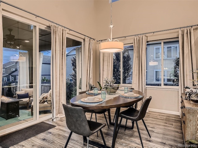 dining area featuring wood finished floors and baseboards