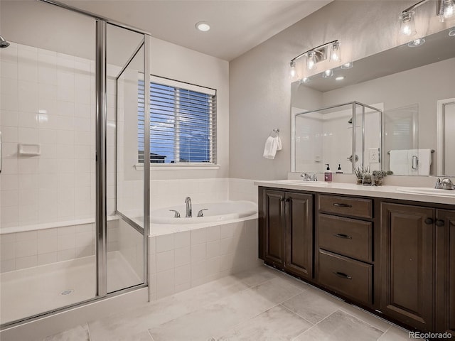 full bath featuring a shower stall, a garden tub, double vanity, and a sink