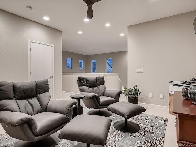 carpeted living area featuring recessed lighting, baseboards, and a ceiling fan