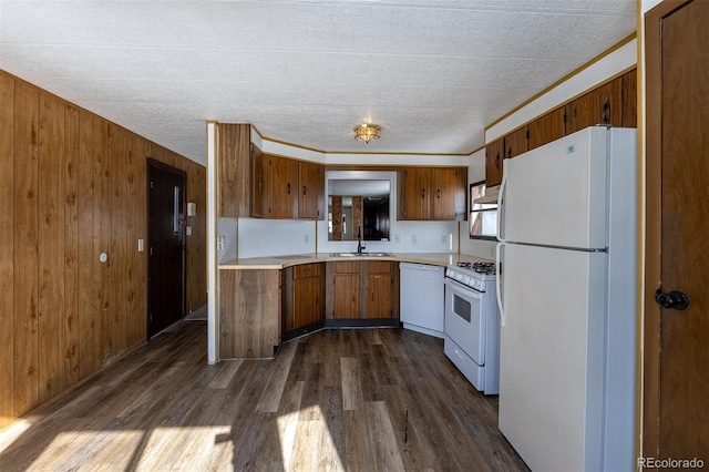 kitchen with white appliances, dark wood-style flooring, a sink, light countertops, and brown cabinetry