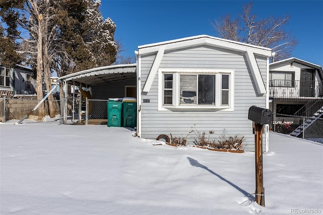 view of front of home featuring a carport and fence