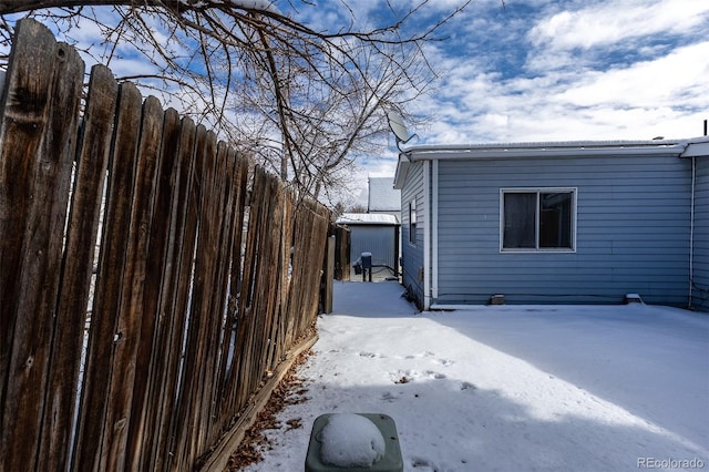 view of snow covered exterior featuring fence