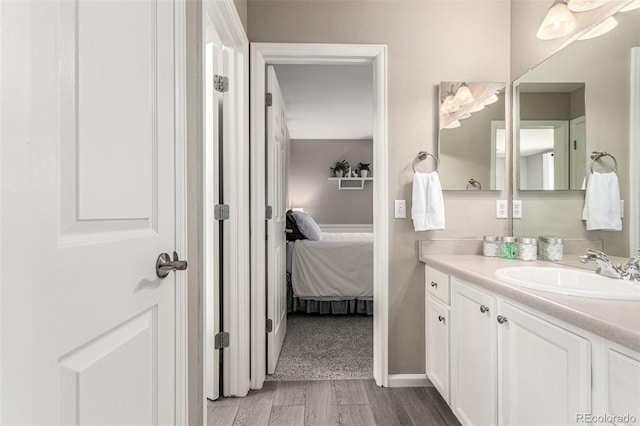 392 Driftwood Cir, Lafayette, CO 80026 - bathroom featuring vanity, wood finished floors, and ensuite bath