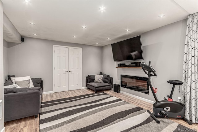 392 Driftwood Cir, Lafayette, CO 80026 - workout area with light wood-style floors, recessed lighting, and a glass covered fireplace