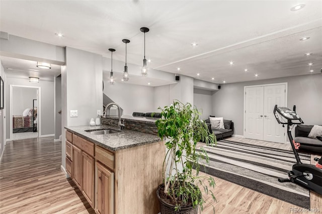 392 Driftwood Cir, Lafayette, CO 80026 - kitchen with open floor plan, light wood-style flooring, dark stone countertops, and recessed lighting