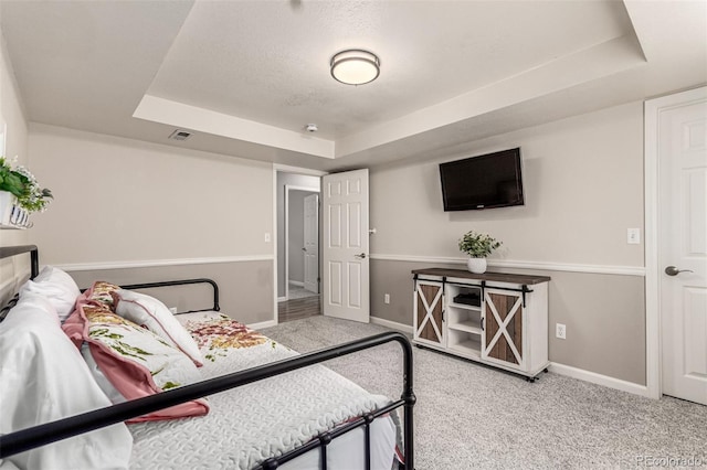 392 Driftwood Cir, Lafayette, CO 80026 - carpeted bedroom featuring a tray ceiling and baseboards