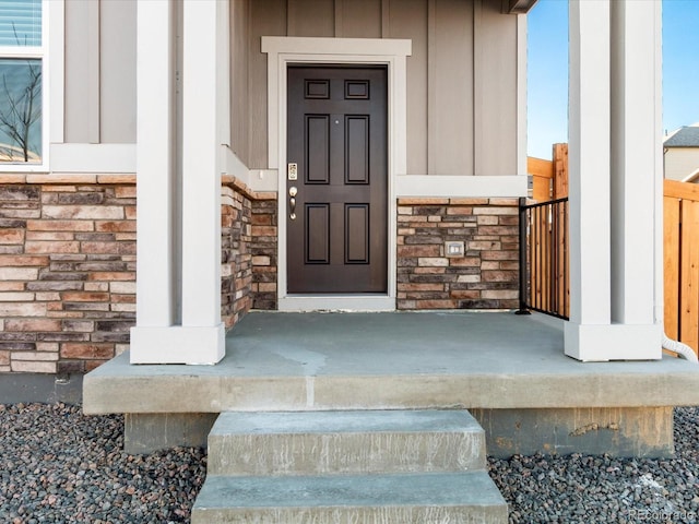 doorway to property with stone siding and board and batten siding