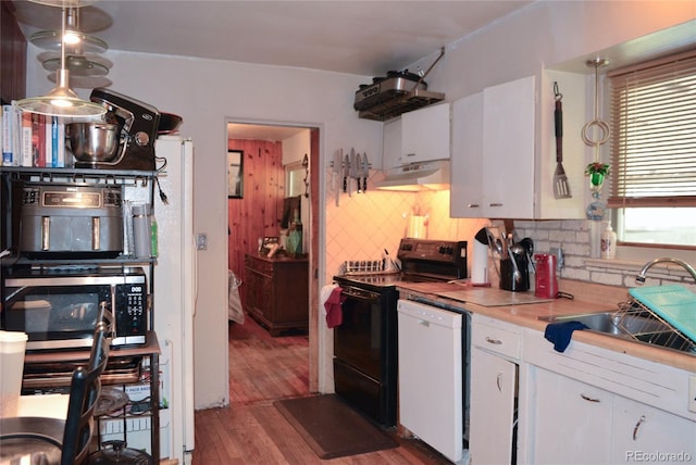 2885 Quay St, Wheat Ridge, CO 80033 - kitchen featuring black range with electric cooktop, stainless steel microwave, dishwasher, under cabinet range hood, and backsplash