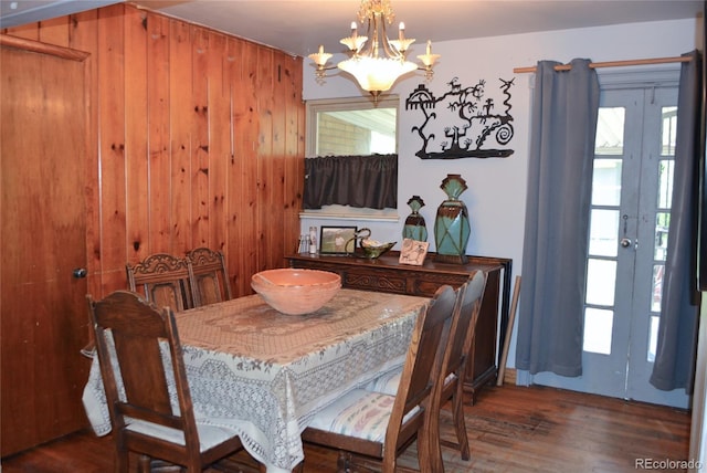 2885 Quay St, Wheat Ridge, CO 80033 - dining room with a chandelier, wood finished floors, plenty of natural light, and wooden walls