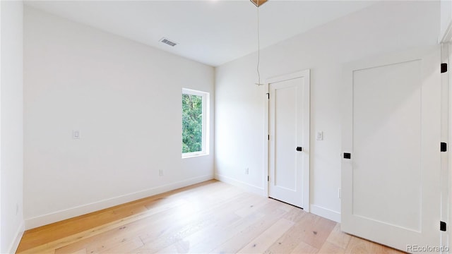 2405 S Franklin, Denver, CO 80210 - unfurnished bedroom with light wood-type flooring and baseboards