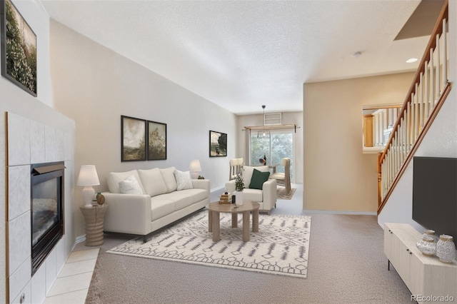 living room featuring light carpet, a fireplace, and a textured ceiling