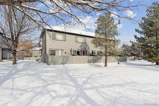 view of snow covered rear of property