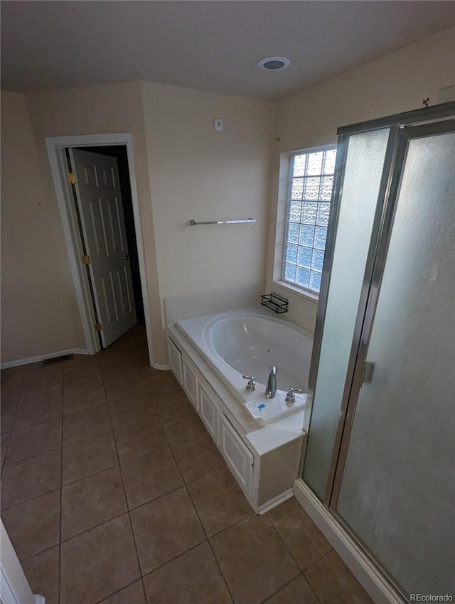 bathroom with shower with separate bathtub and tile patterned floors