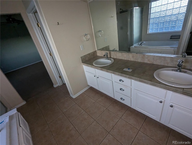 bathroom with tile patterned flooring, vanity, and shower with separate bathtub