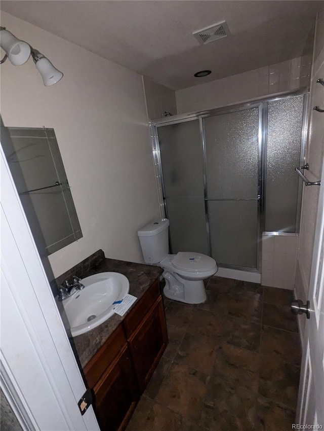 bathroom with toilet, an enclosed shower, and vanity