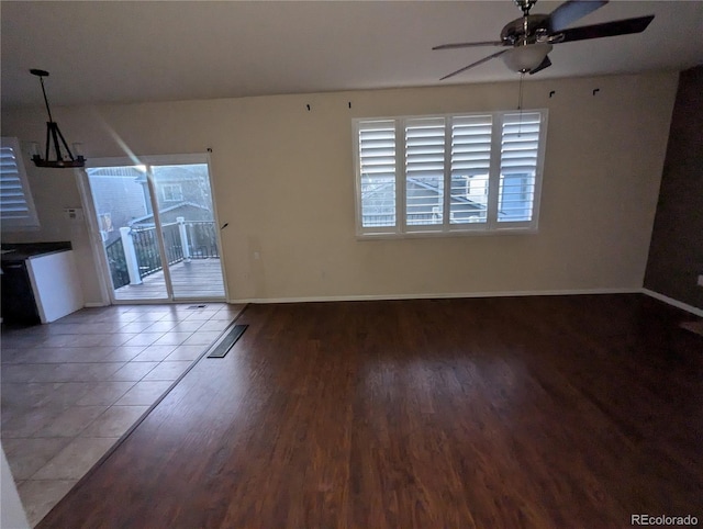 unfurnished living room with tile patterned floors, ceiling fan, and plenty of natural light