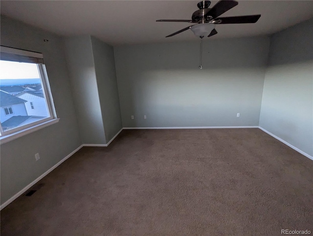 carpeted spare room with ceiling fan