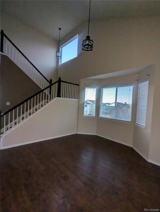 unfurnished living room with a high ceiling