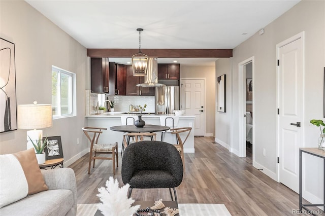 15 Hazel Ct, Denver, CO 80219 - kitchen featuring freestanding refrigerator, light countertops, dark brown cabinetry, decorative backsplash, and a peninsula