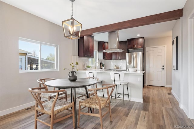 15 Hazel Ct, Denver, CO 80219 - dining space with a chandelier, light wood-style floors, baseboards, recessed lighting, and beam ceiling