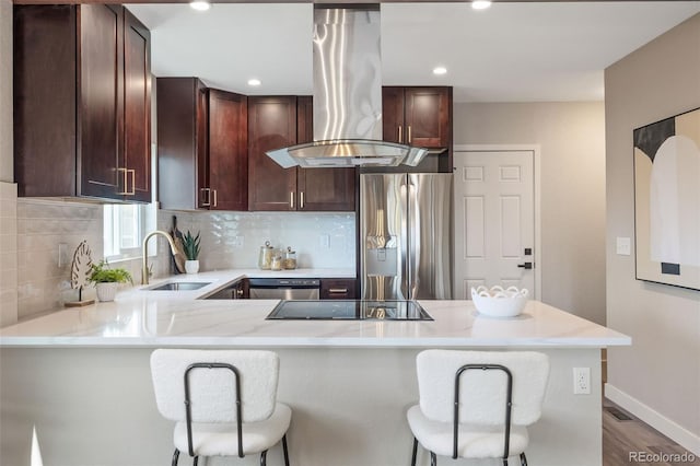 15 Hazel Ct, Denver, CO 80219 - kitchen with island range hood, a sink, appliances with stainless steel finishes, light countertops, and a peninsula