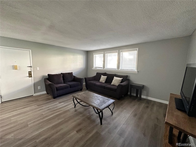 10211 Ura Ln Unit 7-108, Thornton, CO 80260 - living area featuring wood finished floors, a textured ceiling, and baseboards
