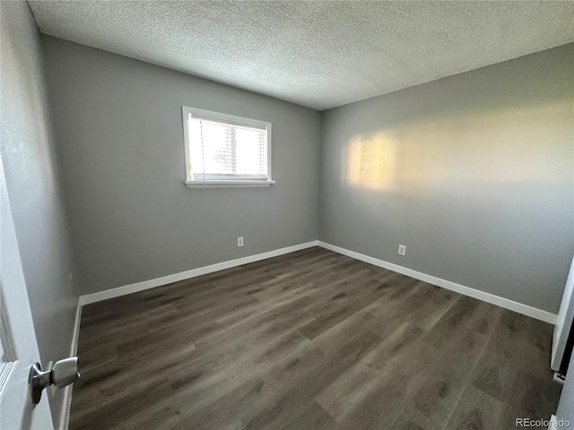 10211 Ura Ln Unit 7-108, Thornton, CO 80260 - empty room with a textured ceiling, dark wood-style floors, and baseboards