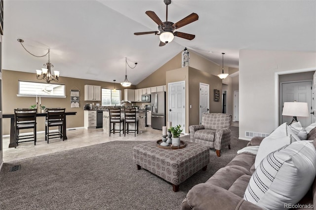 living room featuring ceiling fan, a chandelier, vaulted ceiling, and baseboards