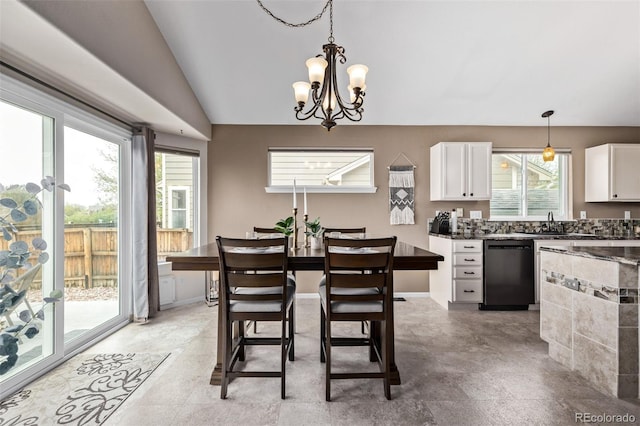 dining space featuring healthy amount of natural light, a chandelier, and lofted ceiling