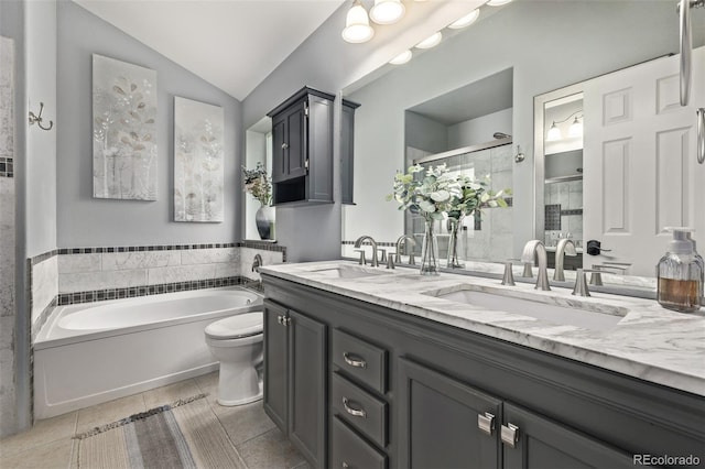 bathroom featuring tile patterned floors, a stall shower, lofted ceiling, double vanity, and a garden tub