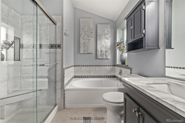 bathroom with a stall shower, a garden tub, vanity, toilet, and lofted ceiling
