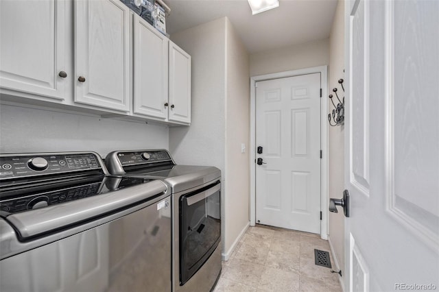 laundry area with separate washer and dryer, cabinet space, and baseboards