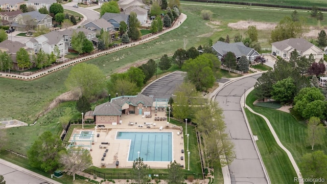 aerial overview of property's location with a pool area and nearby suburban area