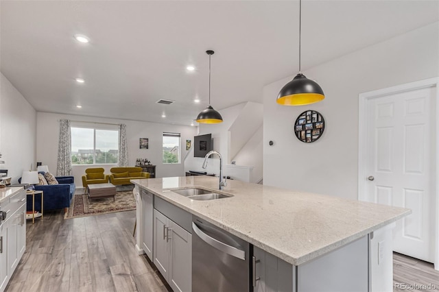 1918 W 165th Way, Broomfield, CO 80023 - kitchen with dishwasher, open floor plan, light wood-style flooring, light stone countertops, and recessed lighting
